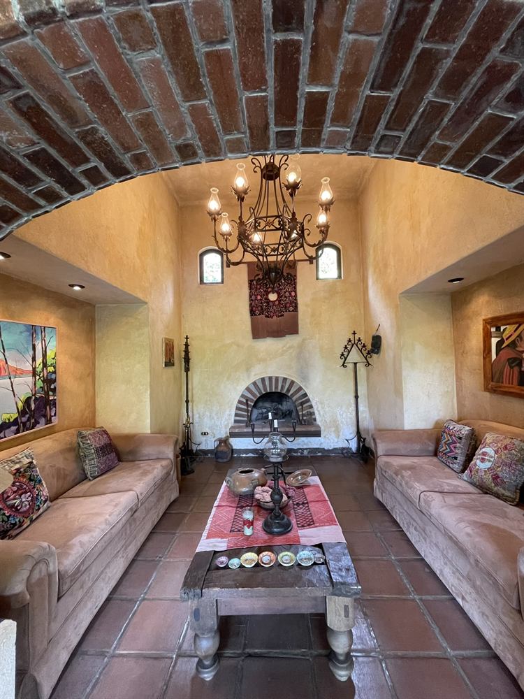 Living room with sofas, brick arch and fireplace